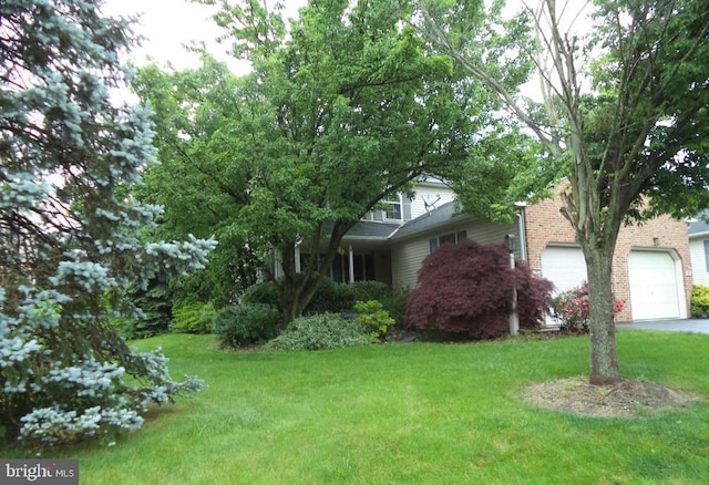 view of front of home with a front lawn and a garage