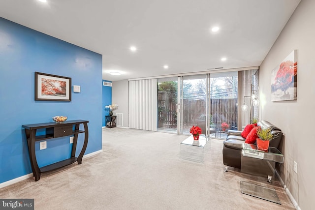 sitting room featuring light carpet