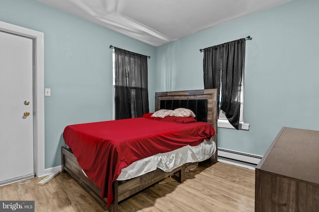 bedroom featuring light hardwood / wood-style floors and a baseboard radiator