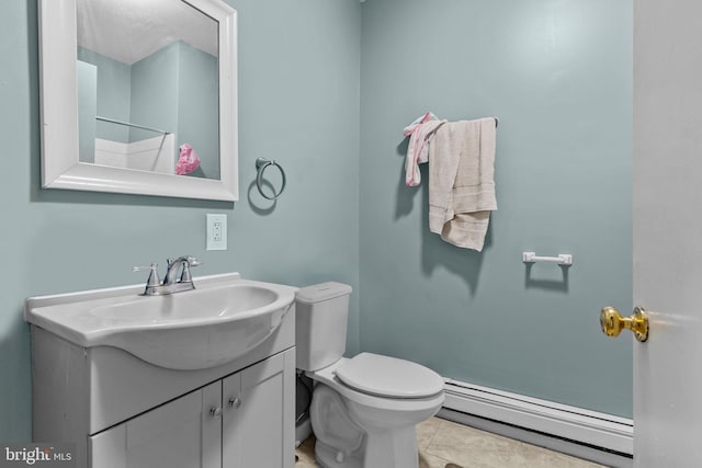 bathroom featuring tile patterned floors, vanity, a baseboard radiator, and toilet