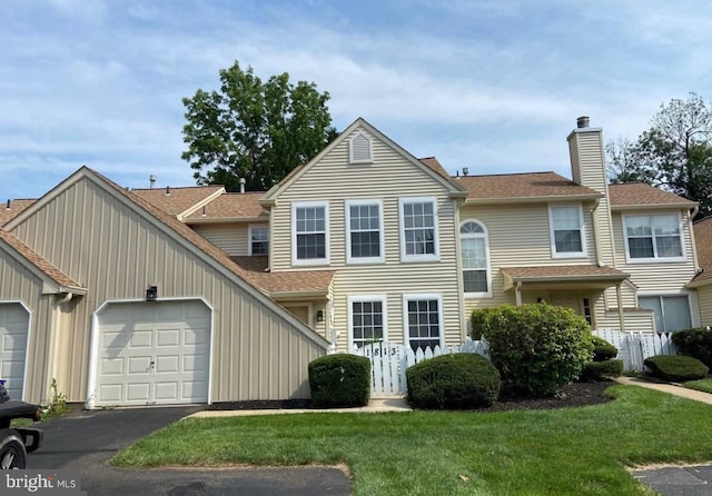 view of front facade featuring a front yard and a garage