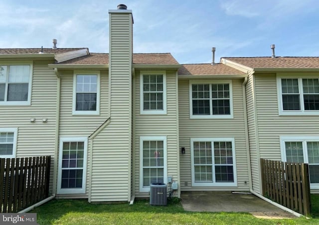 back of property with a patio area and central air condition unit