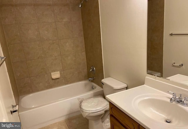 full bathroom featuring tile patterned flooring, vanity, toilet, and tiled shower / bath