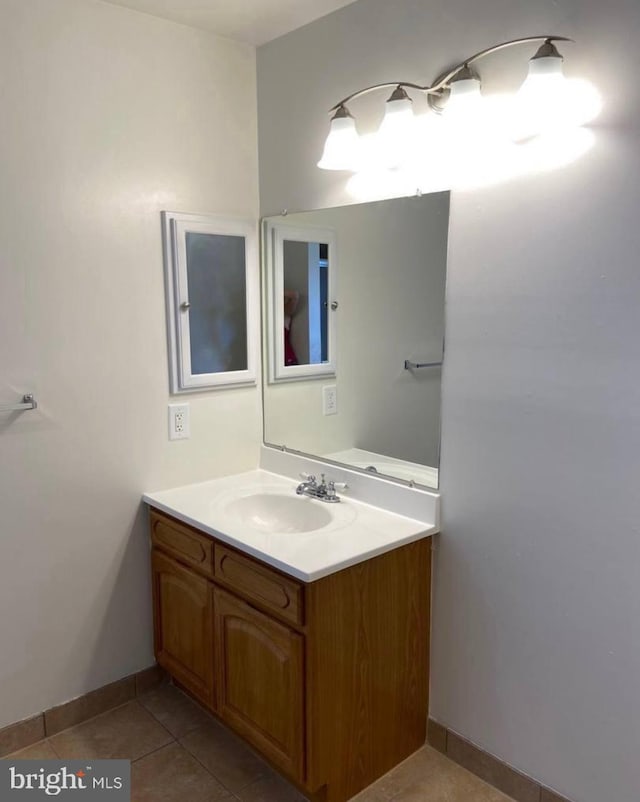 bathroom with tile patterned flooring and vanity