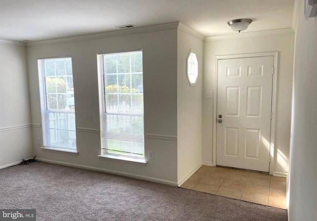 entryway featuring light colored carpet and ornamental molding