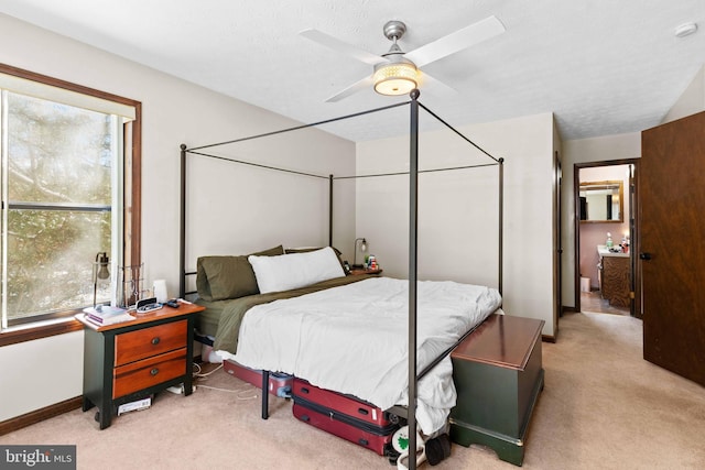 carpeted bedroom featuring a textured ceiling and ceiling fan