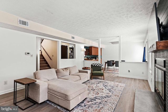 living room featuring a textured ceiling and hardwood / wood-style flooring