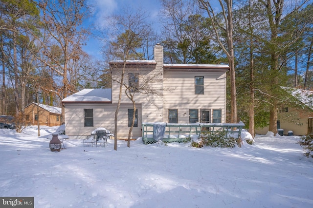 snow covered property featuring a deck