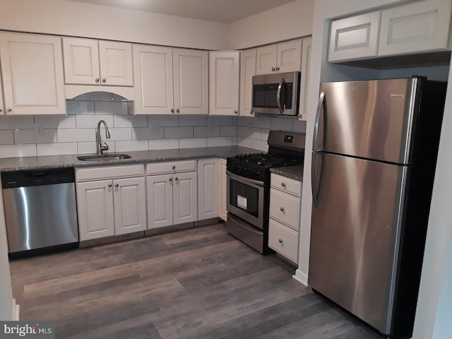 kitchen featuring white cabinetry, sink, dark hardwood / wood-style floors, and appliances with stainless steel finishes