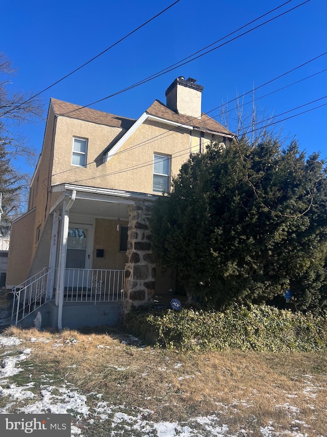 view of side of property with a porch