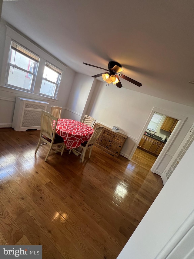 dining area featuring hardwood / wood-style flooring and ceiling fan