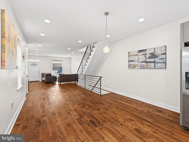 unfurnished living room featuring dark hardwood / wood-style floors