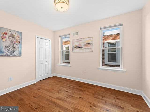 spare room featuring hardwood / wood-style flooring