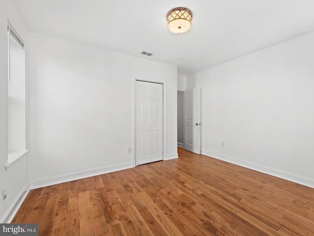 unfurnished room featuring hardwood / wood-style flooring