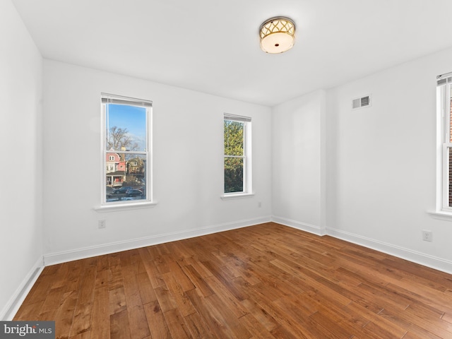 unfurnished room with wood-type flooring