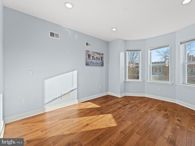 unfurnished room featuring hardwood / wood-style floors