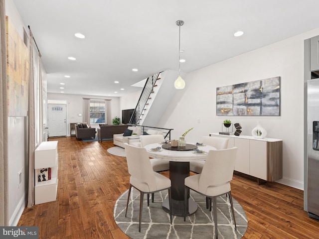 dining space with dark hardwood / wood-style floors