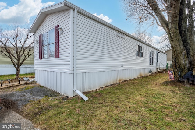 view of side of property featuring a yard