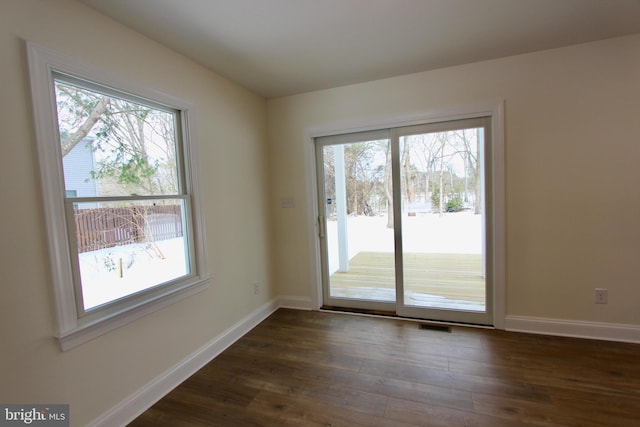 interior space featuring plenty of natural light and dark wood-type flooring