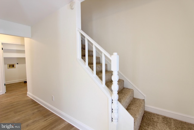 stairs featuring hardwood / wood-style floors