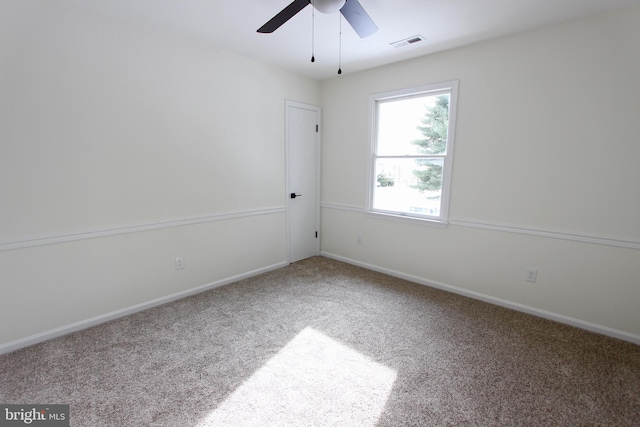 spare room featuring carpet flooring and ceiling fan