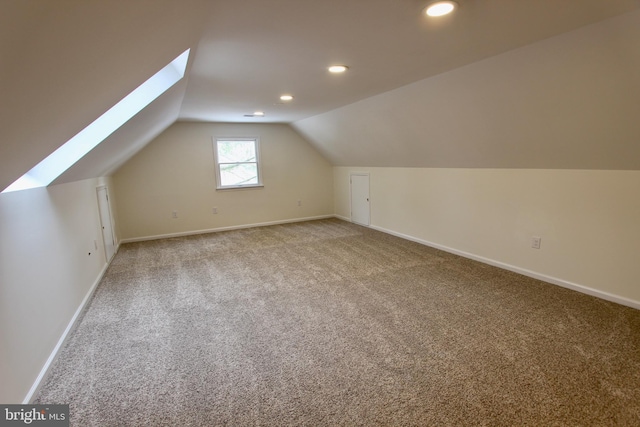 additional living space with carpet flooring and lofted ceiling