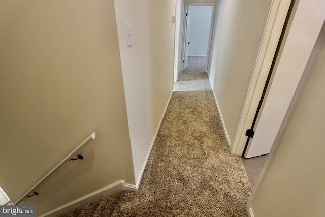 hall with light colored carpet