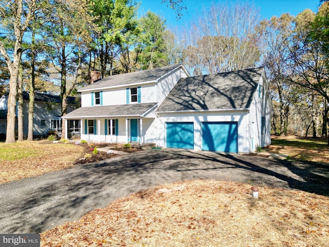 view of front of property with a porch and a garage