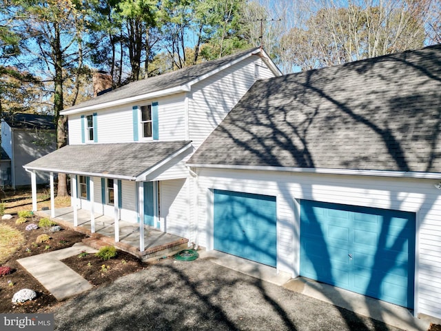 view of front of home featuring covered porch and a garage