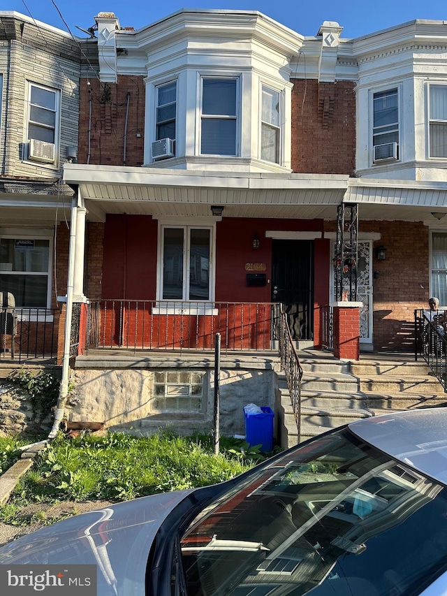 multi unit property featuring cooling unit and covered porch