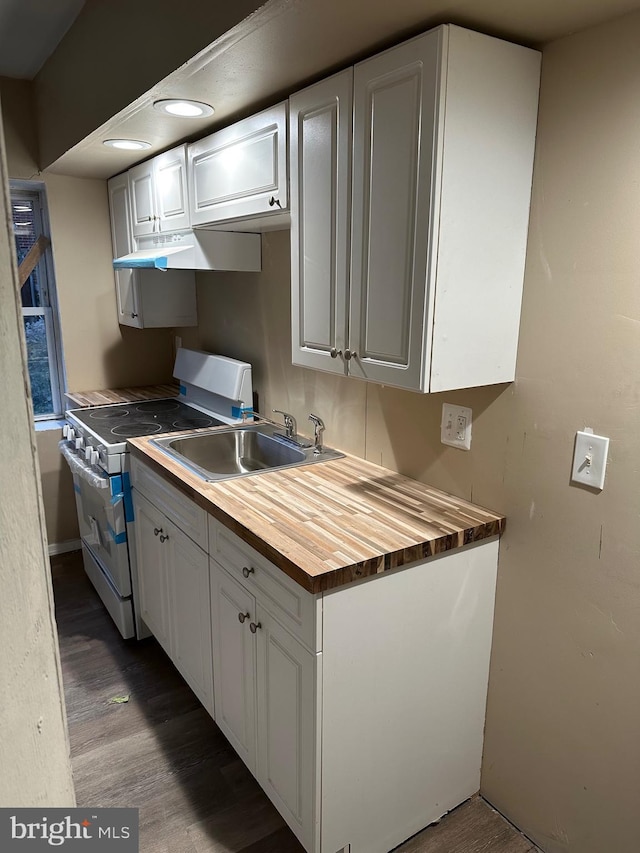 kitchen with sink, white gas range oven, hardwood / wood-style flooring, white cabinetry, and butcher block counters