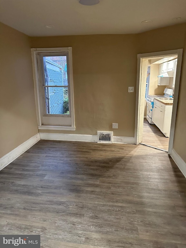 spare room with wood-type flooring