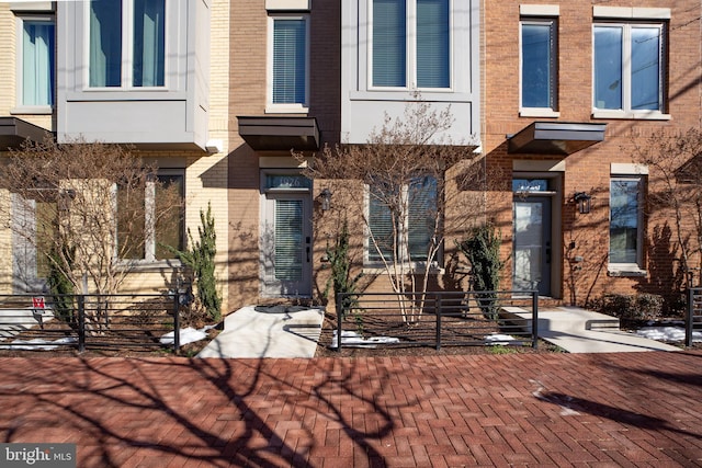 view of exterior entry with brick siding