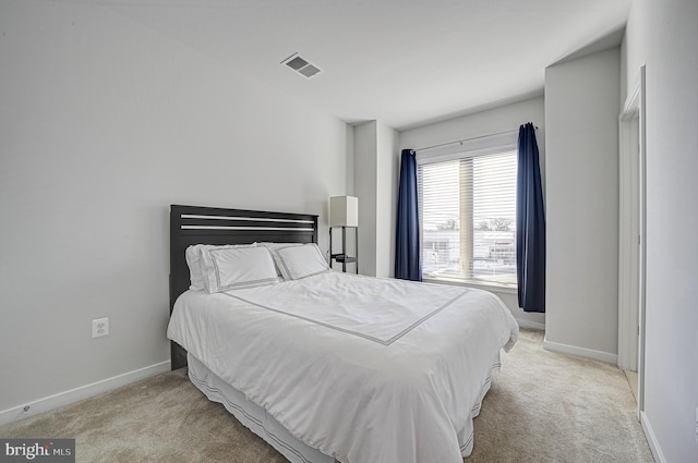 bedroom featuring light colored carpet