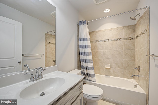 full bathroom featuring toilet, shower / bath combination with curtain, and vanity