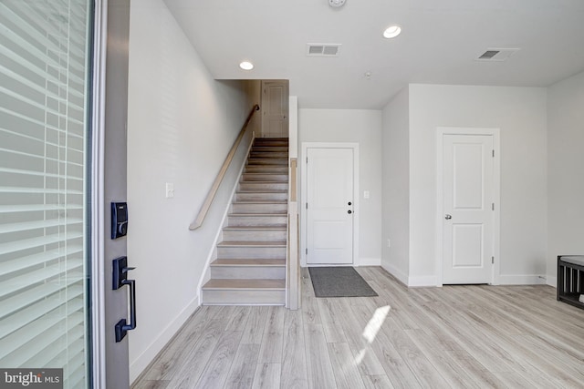 foyer with light hardwood / wood-style floors