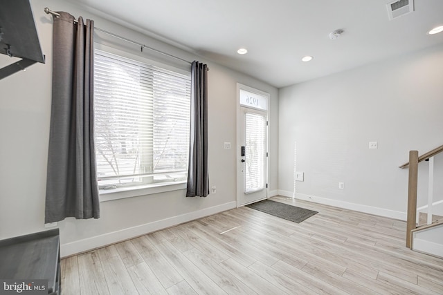 foyer entrance featuring light hardwood / wood-style floors and a healthy amount of sunlight