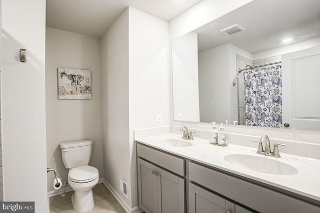 bathroom with a shower with curtain, tile patterned flooring, vanity, and toilet