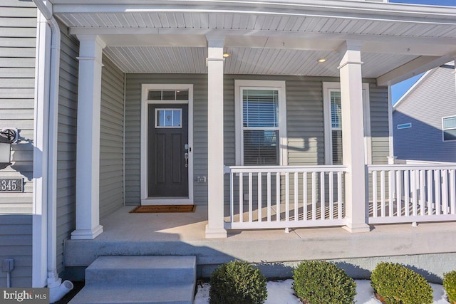 doorway to property featuring covered porch