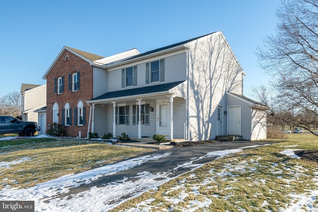 view of front of house with a yard and covered porch