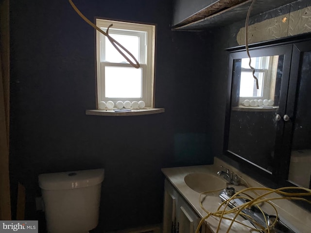 bathroom featuring vanity and toilet