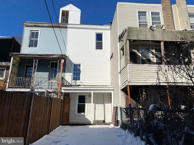 view of snow covered rear of property