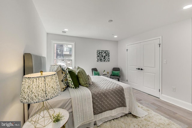 bedroom featuring light hardwood / wood-style floors and a closet