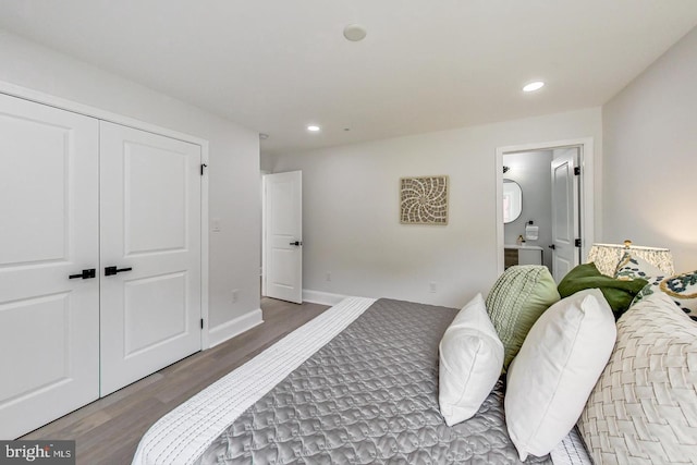 bedroom with a closet and dark wood-type flooring