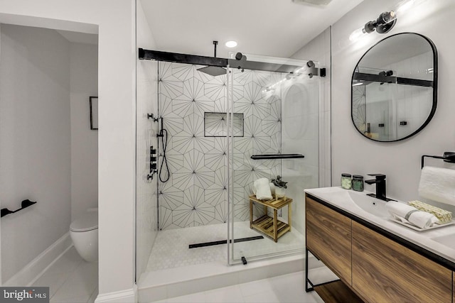 bathroom featuring tile patterned floors, vanity, toilet, and a shower with door