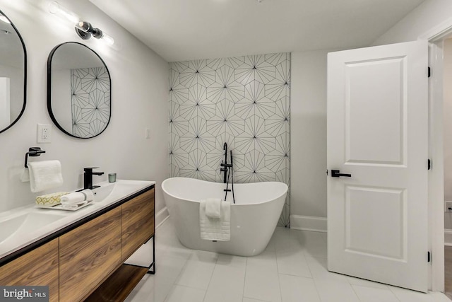 bathroom with a bath, vanity, and tile patterned floors