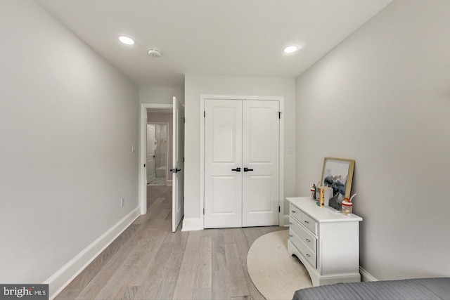 bedroom featuring a closet and light hardwood / wood-style flooring