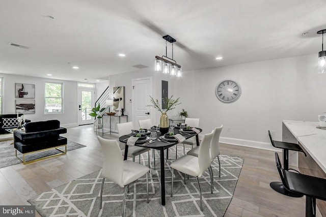 dining space with light hardwood / wood-style flooring