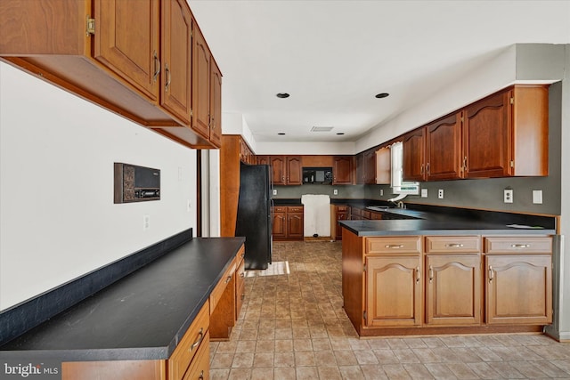 kitchen featuring sink and black appliances