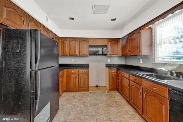 kitchen with sink and black appliances